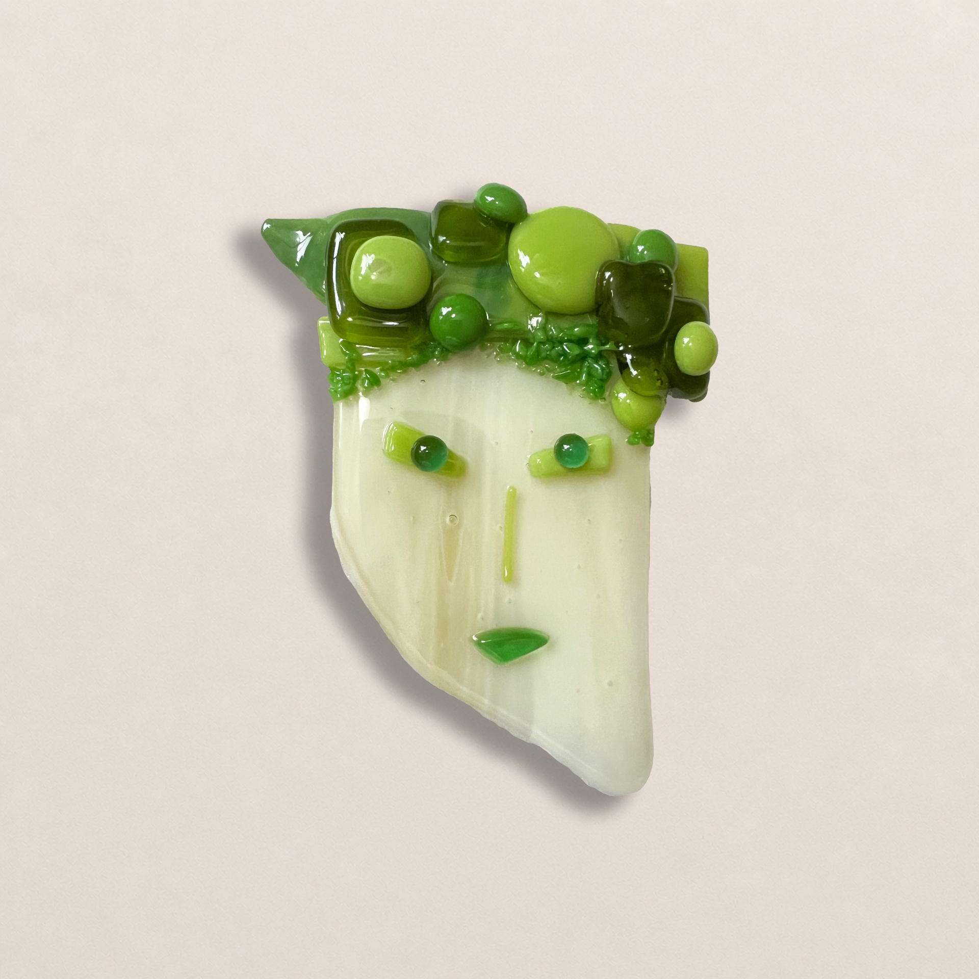 Small green fused glass face by TornadoJane