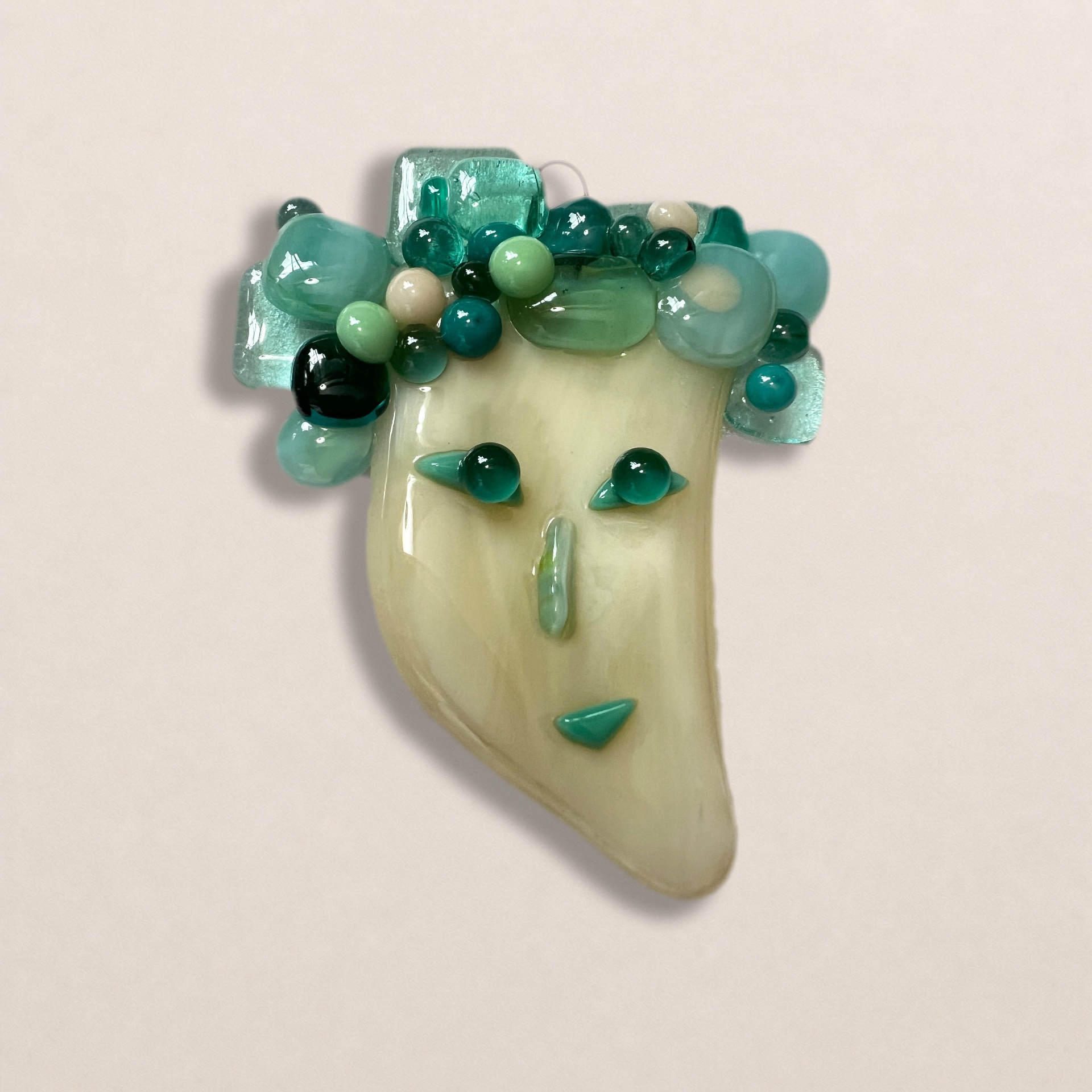 Small teal fused glass face by TornadoJane